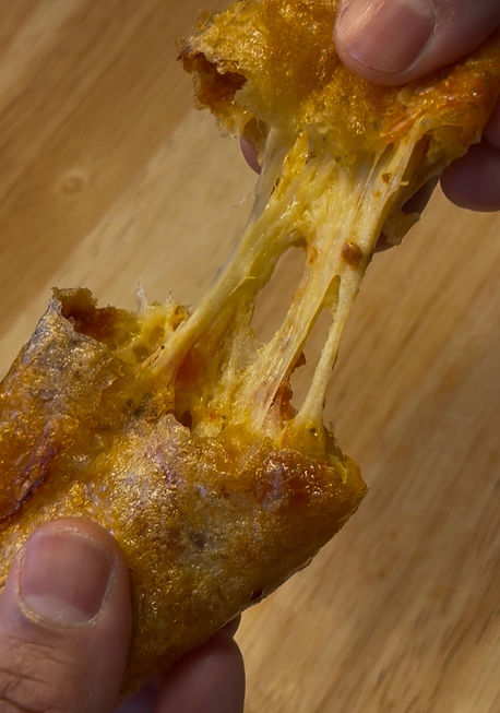 Close-up view of homemade pizza rolls on a wooden board