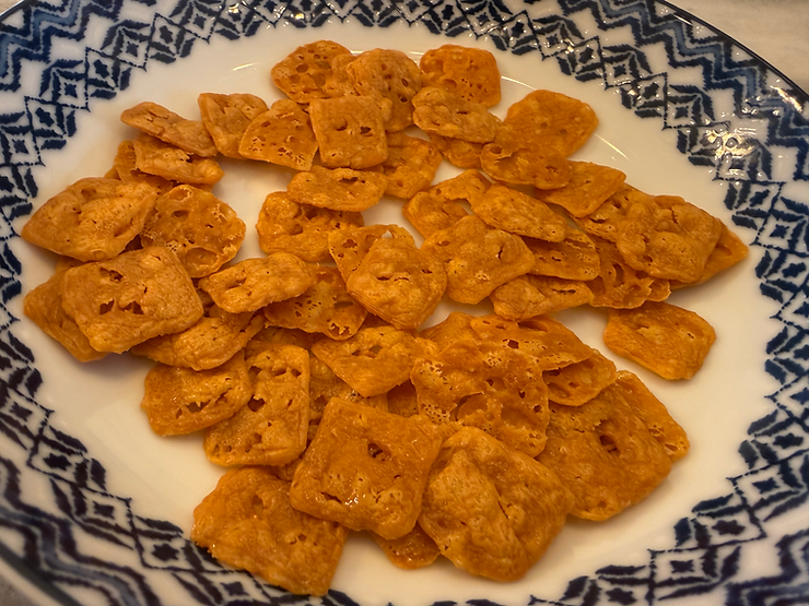 Freshly baked sharp cheddar cheese squares ready to eat